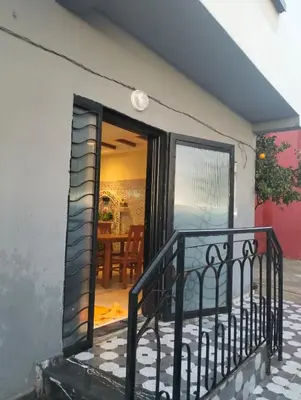 an open door to a patio with a table at RiadNA in Bouznika
