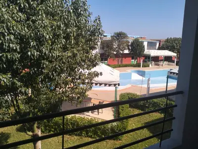 a view of a swimming pool from a balcony at RiadNA in Bouznika