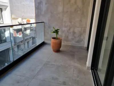 a potted plant sitting on a floor next to a window at Badji in Casablanca