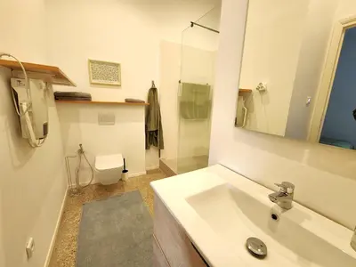 a white bathroom with a sink and a toilet at The 31 Grand Théâtre by IB Signature - Boho Chic 1BR Apt - with Wifi - Self check-in - 24 x7 Security - City View with terrace - Walk to Cafes! City Centre, Tram in Casablanca
