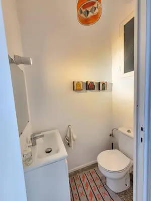 a bathroom with a white toilet and a sink at The 31 Grand Théâtre by IB Signature - Boho Chic 1BR Apt - with Wifi - Self check-in - 24 x7 Security - City View with terrace - Walk to Cafes! City Centre, Tram in Casablanca