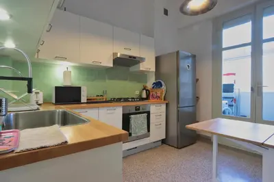 a kitchen with a sink and a refrigerator at The 31 Grand Théâtre by IB Signature - Boho Chic 1BR Apt - with Wifi - Self check-in - 24 x7 Security - City View with terrace - Walk to Cafes! City Centre, Tram in Casablanca