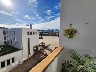 a balcony of a white building with plants on it at The 31 Grand Théâtre by IB Signature - Boho Chic 1BR Apt - with Wifi - Self check-in - 24 x7 Security - City View with terrace - Walk to Cafes! City Centre, Tram in Casablanca