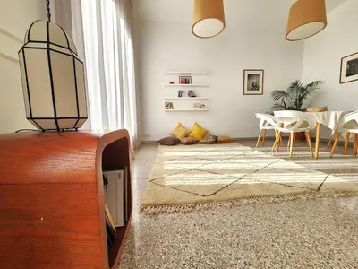 a living room with a tv and a table at The 31 Grand Théâtre by IB Signature - Boho Chic 1BR Apt - with Wifi - Self check-in - 24 x7 Security - City View with terrace - Walk to Cafes! City Centre, Tram in Casablanca