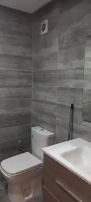 a bathroom with a white toilet and a sink at le joyau de Parc Group A imm B in Mohammedia