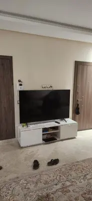 a living room with a large flat screen tv at le joyau de Parc Group A imm B in Mohammedia