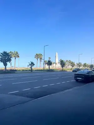 a street with cars parked on the side of the road at Appartement sur bd la corniche luxury house with garden close to beach in Casablanca