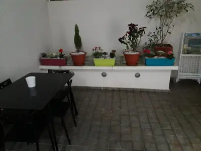 a room with a table and potted plants on a shelf at Appartement sur bd la corniche luxury house with garden close to beach in Casablanca