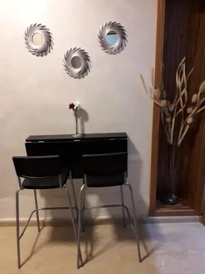 a desk with two mirrors and a vase with a flower at Appartement sur bd la corniche luxury house with garden close to beach in Casablanca