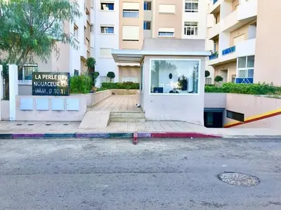 a building with a door on the side of a street at Appartement de luxe à 3 min de l aéroport in Nouaseur