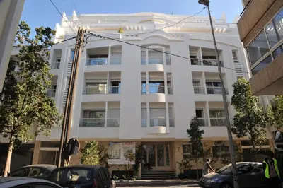 a white building with cars parked in front of it at Appartement à gauthier in Casablanca