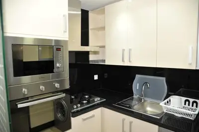 a kitchen with a sink and a stove top oven at Appartement à gauthier in Casablanca