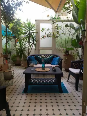a patio with a couch and a coffee table at Appartement à gauthier in Casablanca