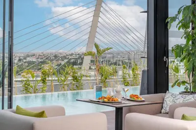 a view of a pool from a hotel room with a table and chairs at Kenzi Sidi Maarouf in Casablanca
