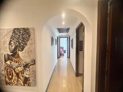 a hallway with a painting of a woman on the wall at Évasion océanique skhirat in Skhirat