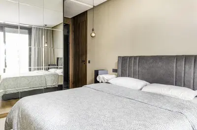 a bedroom with a large bed and a mirror at Luxury 1-Bedroom Apartment in Casablanca