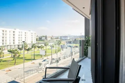 a balcony with a view of a city street at Luxury 1-Bedroom Apartment in Casablanca