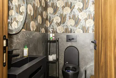 a bathroom with a black toilet and a sink at Luxury 1-Bedroom Apartment in Casablanca