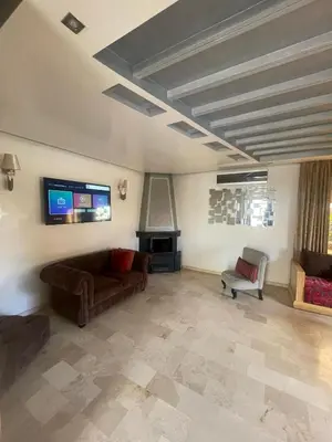 a living room with a couch and a tv at Maison fantastique à louer à Harhoura près de la plage Votre maison côtière de rêve in Temara