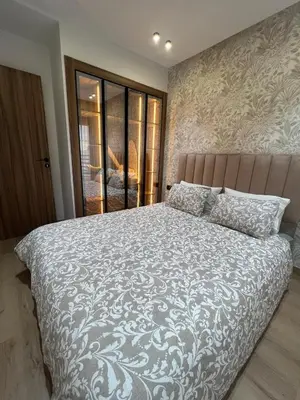 a bedroom with a large bed with a white comforter at Élégant Studio Centre Casablanca in Casablanca