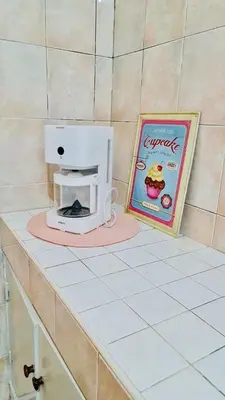 a counter with a small appliance on it next to a sign at 3Bed-Room Appart Agdal City Center in Rabat
