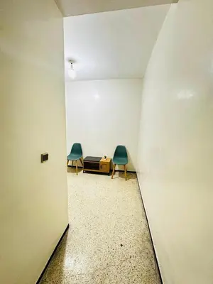 an empty room with two chairs and a table at 3Bed-Room Appart Agdal City Center in Rabat