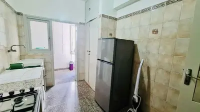 a kitchen with a refrigerator and a sink in it at 3Bed-Room Appart Agdal City Center in Rabat