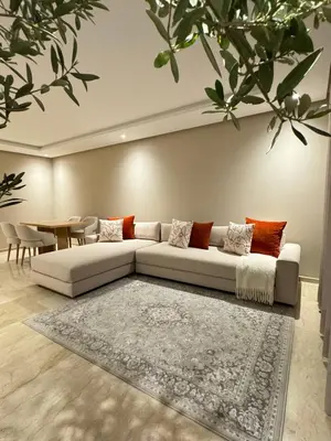 a living room with a white couch and a table at Minimalist Escape - Between Rabat Agdal Station & Corniche in Rabat