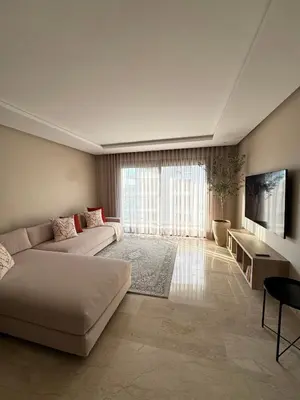 a large living room with a couch and a tv at Minimalist Escape - Between Rabat Agdal Station & Corniche in Rabat