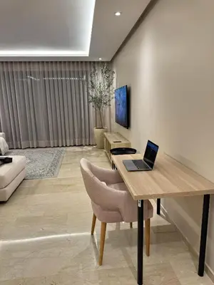 a room with a desk with a laptop on it at Minimalist Escape - Between Rabat Agdal Station & Corniche in Rabat