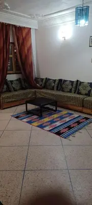 a living room with a couch and a rug at CasAmer in Temara