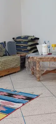 a room with a table and a pile of blankets at CasAmer in Temara