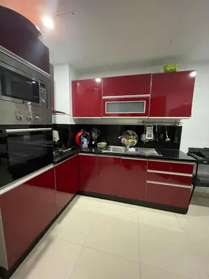 a kitchen with red cabinets and stainless steel appliances at Beachside Charming Apartment in Tamaris