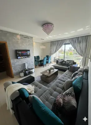 a living room with a couch and a tv at Beachside Charming Apartment in Tamaris