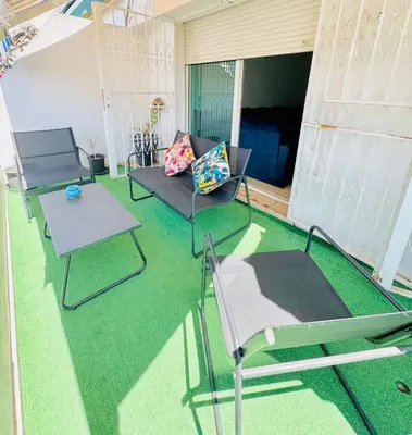 a patio with two chairs and a couch at Appartement Agdal, proche des stades in Rabat