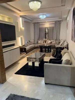 a large living room with a couch and a tv at Corniche in Casablanca