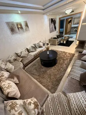 a living room with a couch and a table at Corniche in Casablanca
