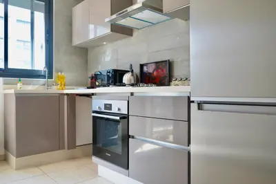 a kitchen with stainless steel appliances and a window at Stylish Luxe Apartment Casablanca Finance City! in Casablanca