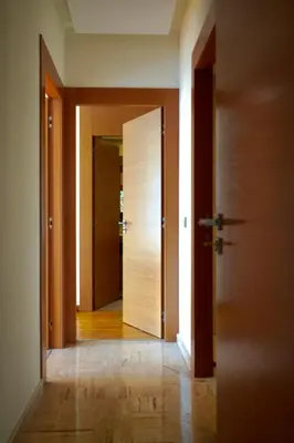an empty hallway with two doors and a wooden floor at Stylish Luxe Apartment Casablanca Finance City! in Casablanca