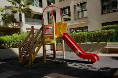 a playground with a slide and a slideintend at Stylish Luxe Apartment Casablanca Finance City! in Casablanca