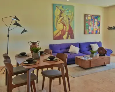 a living room with a table and a purple couch at Stylish Luxe Apartment Casablanca Finance City! in Casablanca