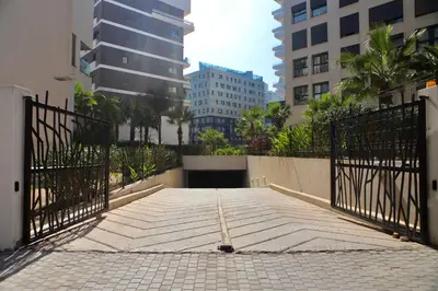a gate in the middle of a city with buildings at Stylish Luxe Apartment Casablanca Finance City! in Casablanca