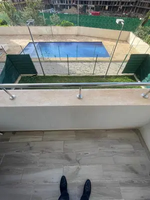 a person standing in front of a swimming pool at Studio moderne et élégant Idéal pour un séjour confortable in Rabat