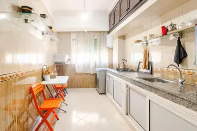 a kitchen with a sink and a table and chairs at Modern hideaway in Casablanca in Casablanca
