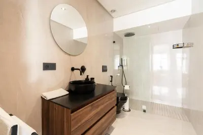 a bathroom with a sink and a mirror at Casablanca Maarif 1BR With Private Patio And Parking in Casablanca