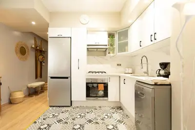 a kitchen with white cabinets and a refrigerator at Appartement 2 pièces au cœur de Casablanca in Casablanca