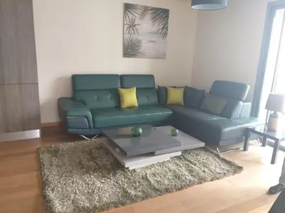a living room with a green couch and a coffee table at Stunning one bedroom flat at Casablanca Marina 10th floor Sea View in Casablanca