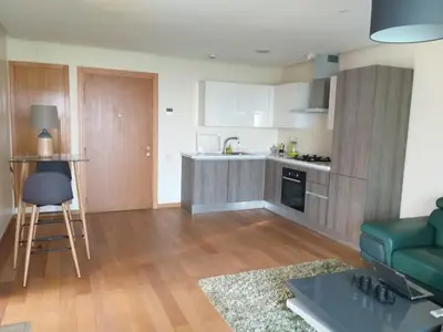 a kitchen and living room with a couch and a table at Stunning one bedroom flat at Casablanca Marina 10th floor Sea View in Casablanca