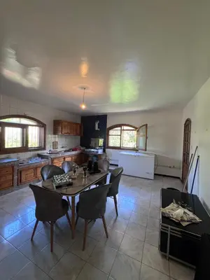 a kitchen with a table and chairs in a room at Villa élégante à Rabat,harhoura à 4 chambres in Rabat