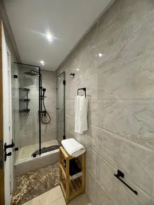 a bathroom with a shower and a toilet and a sink at Moderne berlin av terrasse in Rabat